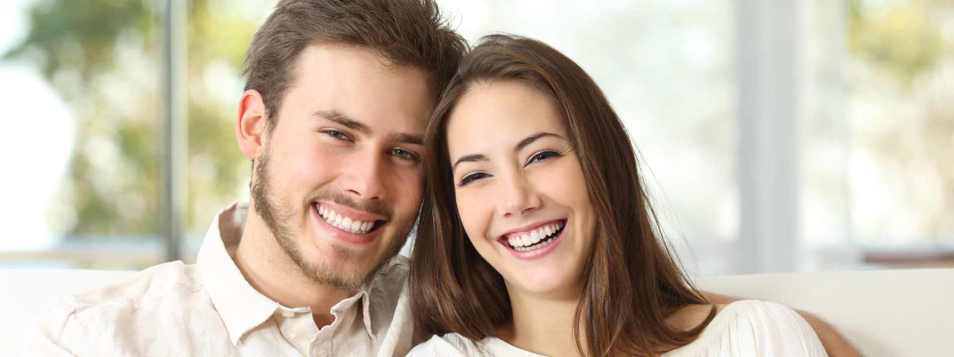 Happiness and Dental Confidence: Couple's Bright Smiles Achieved through Expert Dentistry